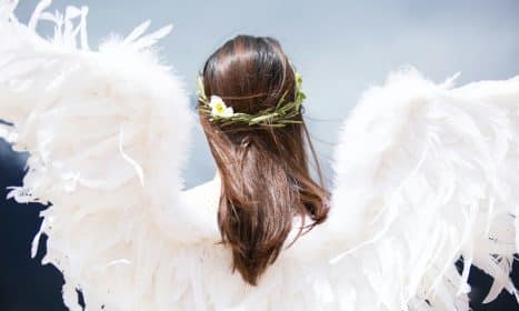 woman wearing white angel wings
