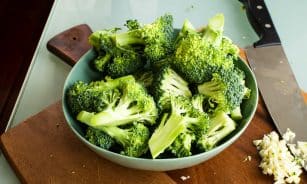 green broccoli on brown wooden chopping board