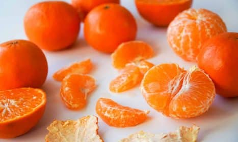 sliced orange fruits on white ceramic plate