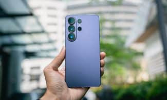 Hand holding a purple smartphone with multiple cameras.