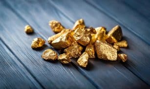 A pile of gold nuggets sitting on top of a wooden table