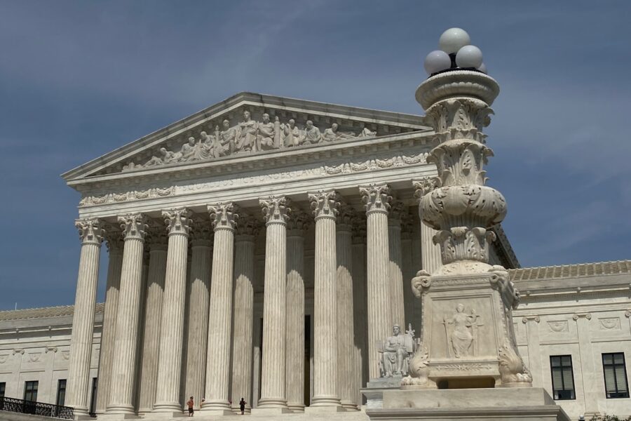a large building with columns and a clock on top of it
