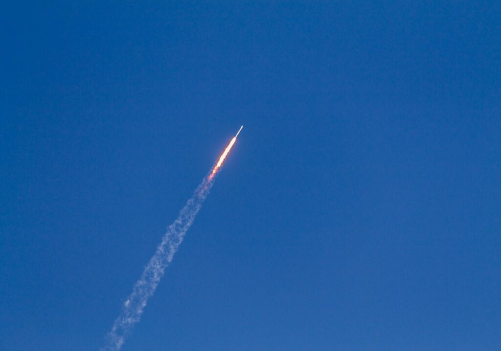 flying rocket during daytime