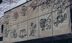 a building that has a bunch of drawings on it