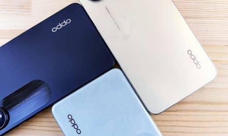 three oppo phones sitting on top of a wooden table