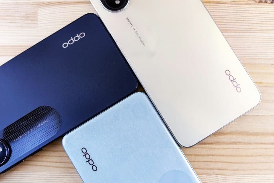 three oppo phones sitting on top of a wooden table