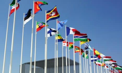 a bunch of flags that are flying in the air