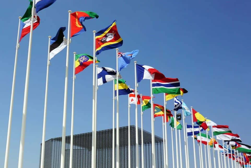 a bunch of flags that are flying in the air