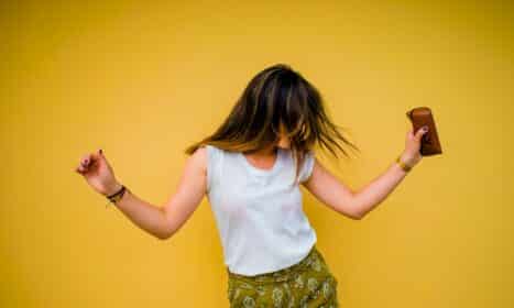 woman standing near yellow wall