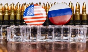 a bunch of bullet casings with flags on them