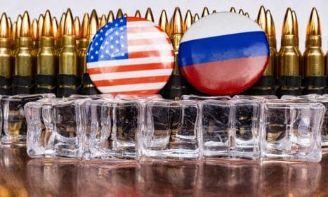 a bunch of bullet casings with flags on them