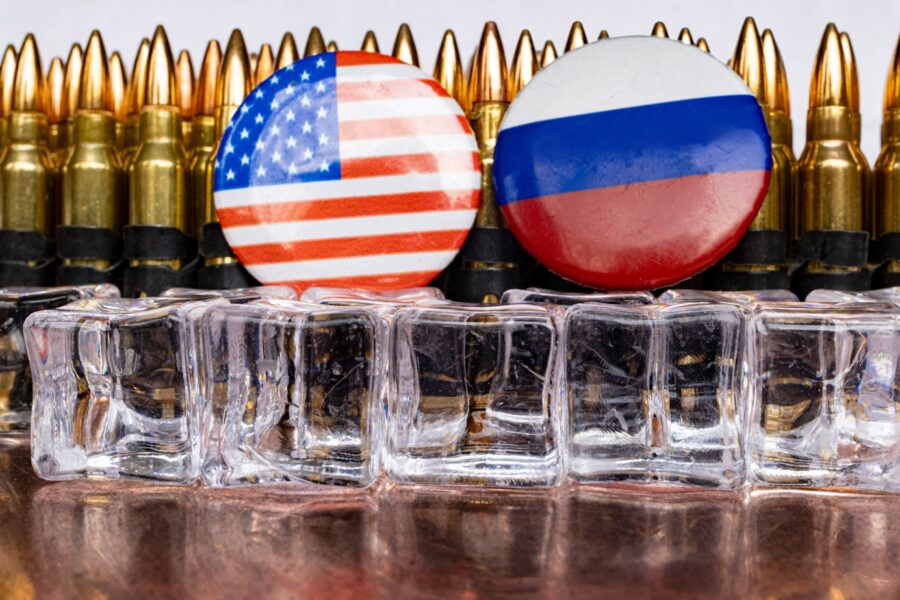 a bunch of bullet casings with flags on them