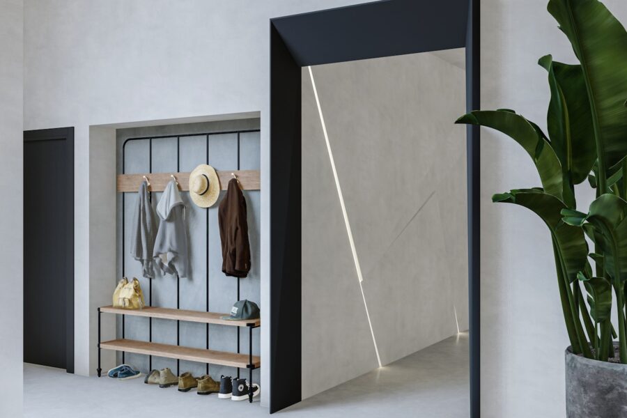 a room with a plant and a coat rack