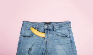 blue denim jeans on white textile