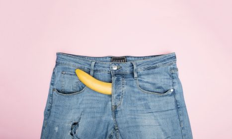 blue denim jeans on white textile