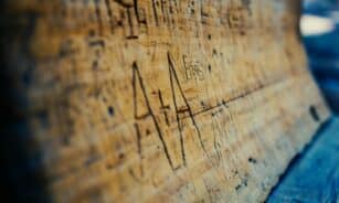a piece of wood with writing on it