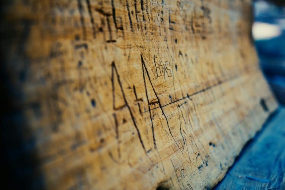 a piece of wood with writing on it