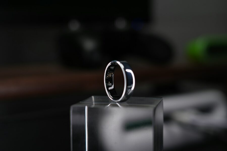 A smart ring is displayed on a clear block.
