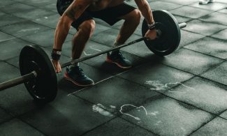 man holding dumbbells