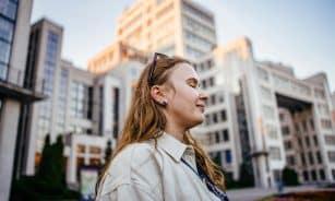 Woman poses in front of a building.