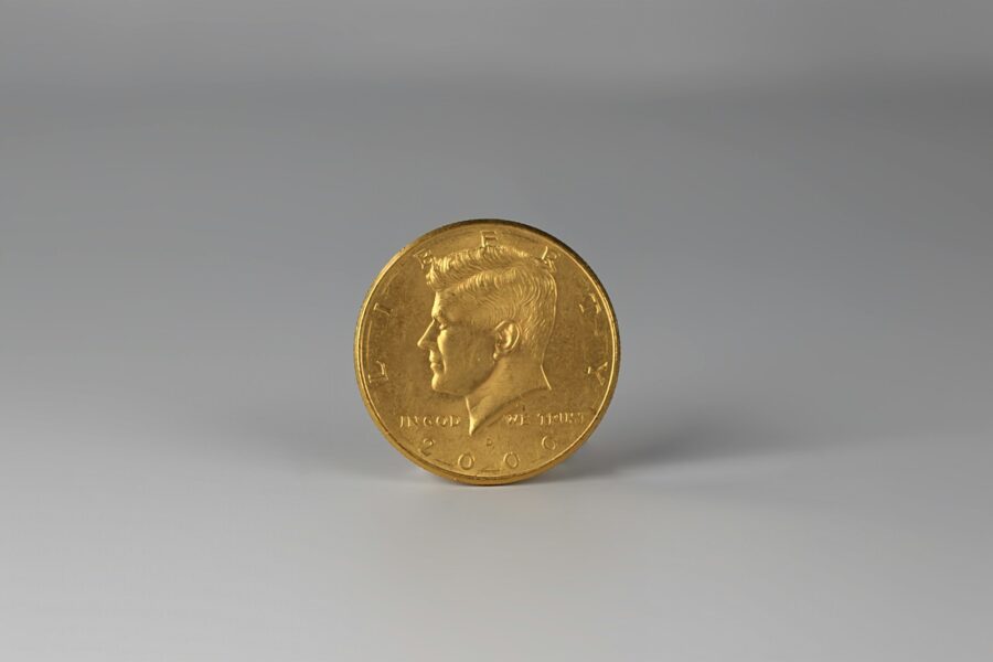 a close up of a gold coin on a white surface