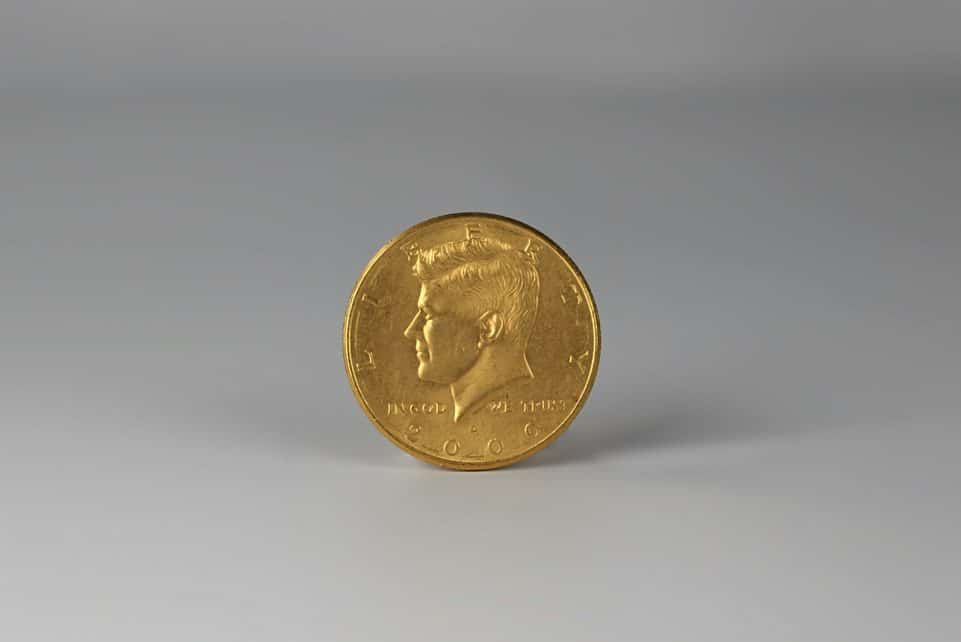 a close up of a gold coin on a white surface