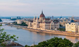 brown concrete building near body of water during daytime