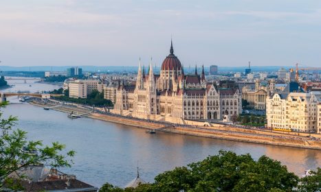 brown concrete building near body of water during daytime