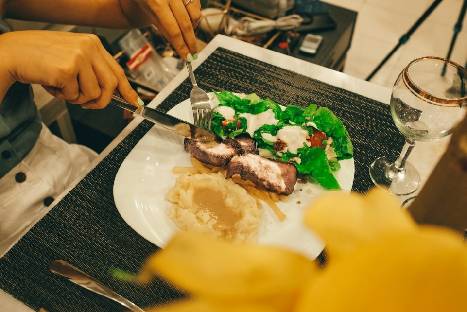 person slicing the dish photography