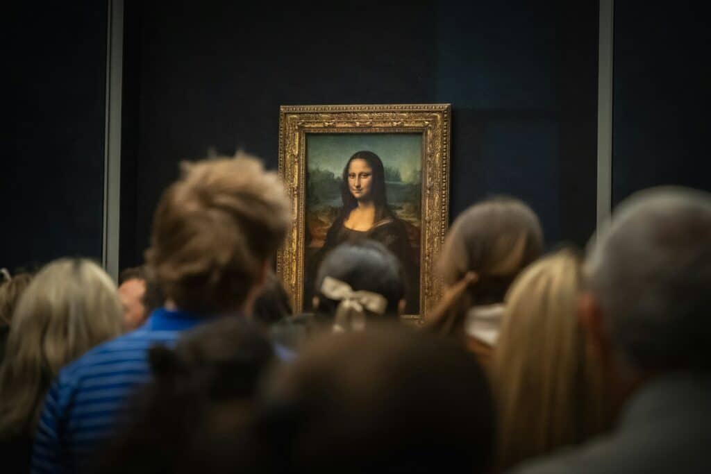 A crowd of people looking at a painting