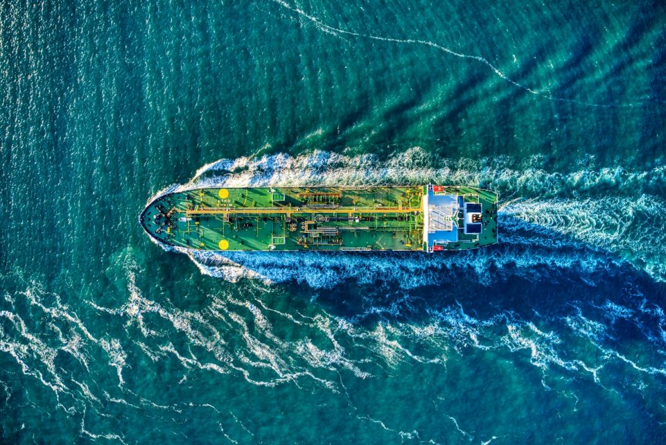 aerial view of white and yellow boat on body of water during daytime