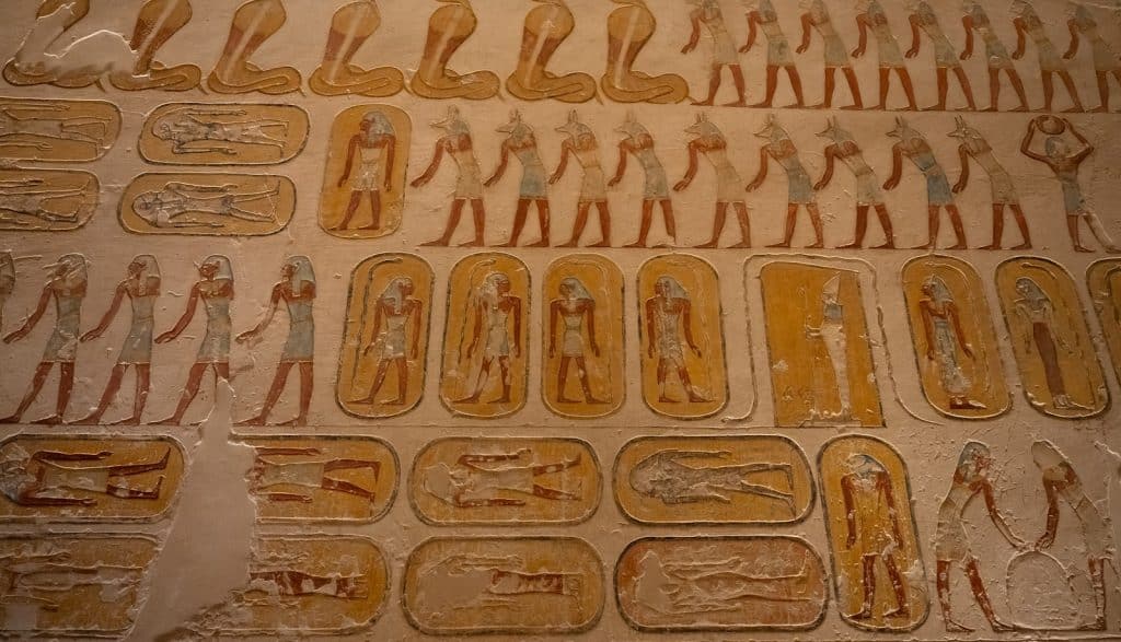 Ancient egyptian hieroglyphs and figures on a tomb wall