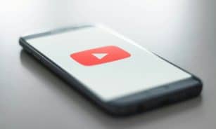 a close up of a cell phone with a youtube logo on it