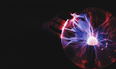 human hand holding plasma ball