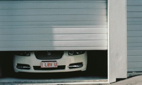 black and silver car in front of garage door