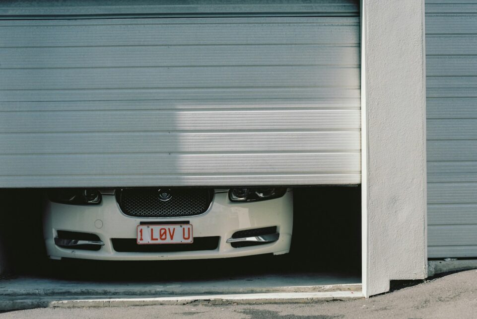 black and silver car in front of garage door