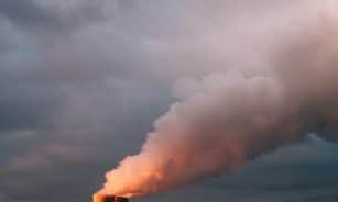 sea waves crashing on shore under white clouds