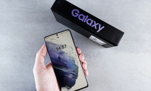 a person holding a cell phone in their hand