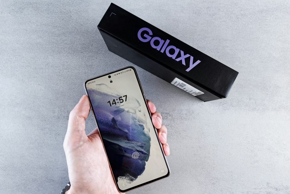 a person holding a cell phone in their hand