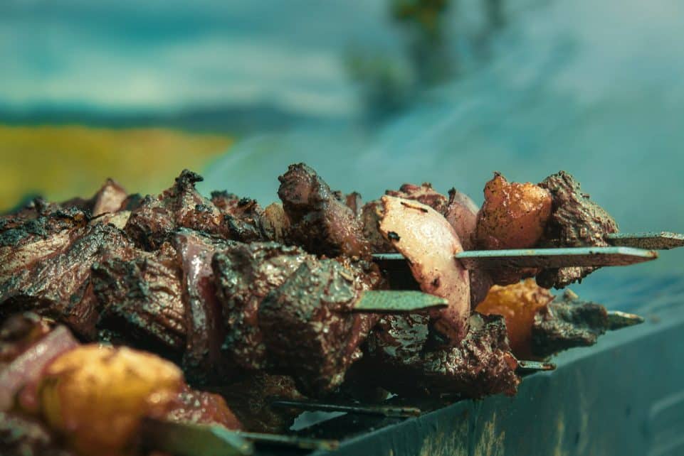 A close up of a skewer of food on a grill
