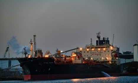 a large cargo ship in a harbor at night