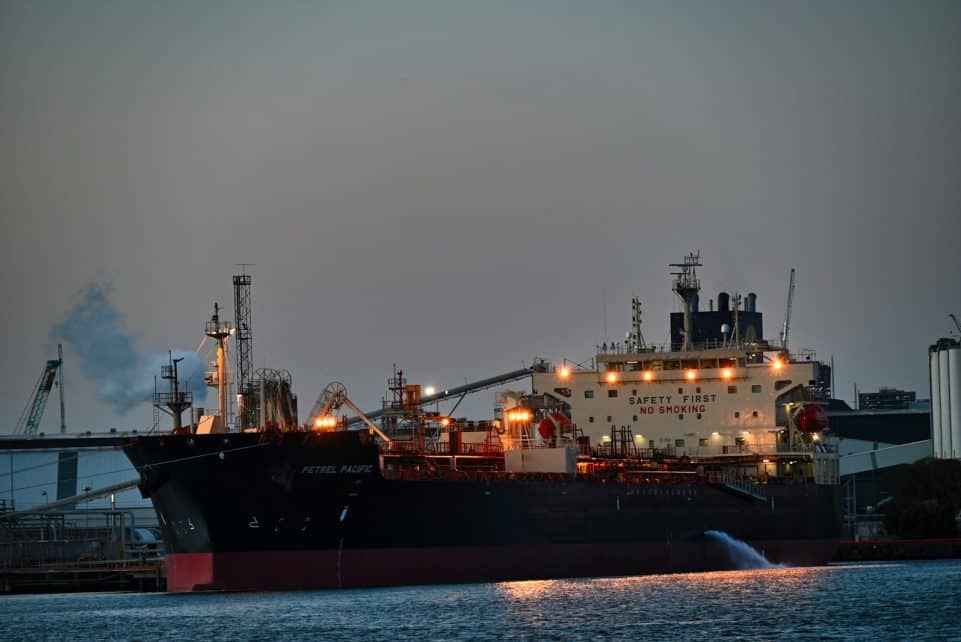 a large cargo ship in a harbor at night