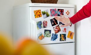 a refrigerator with pictures of fruits and vegetables on it