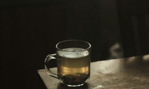 clear glass mug with brown liquid