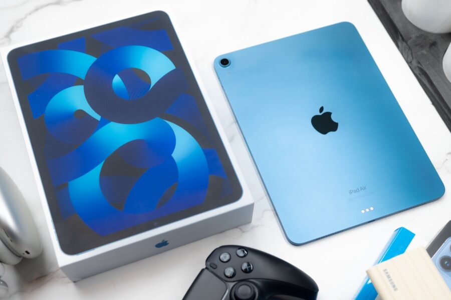 a table topped with an ipad and a controller
