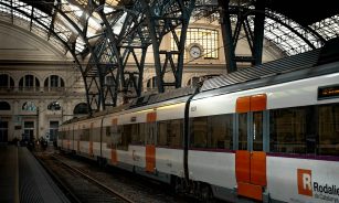 white red and black train on rail tracks