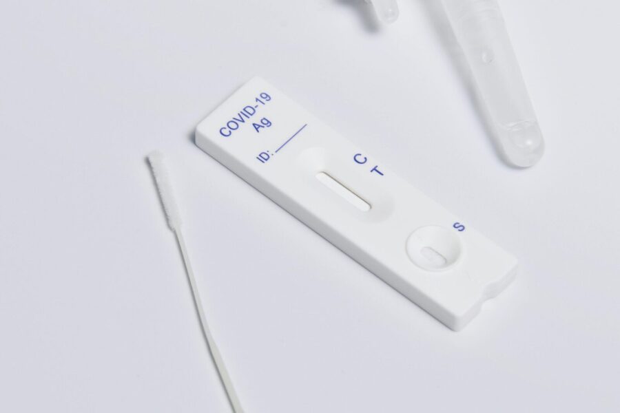 Close-up of a COVID-19 rapid antigen test kit showing the testing strip and swab.