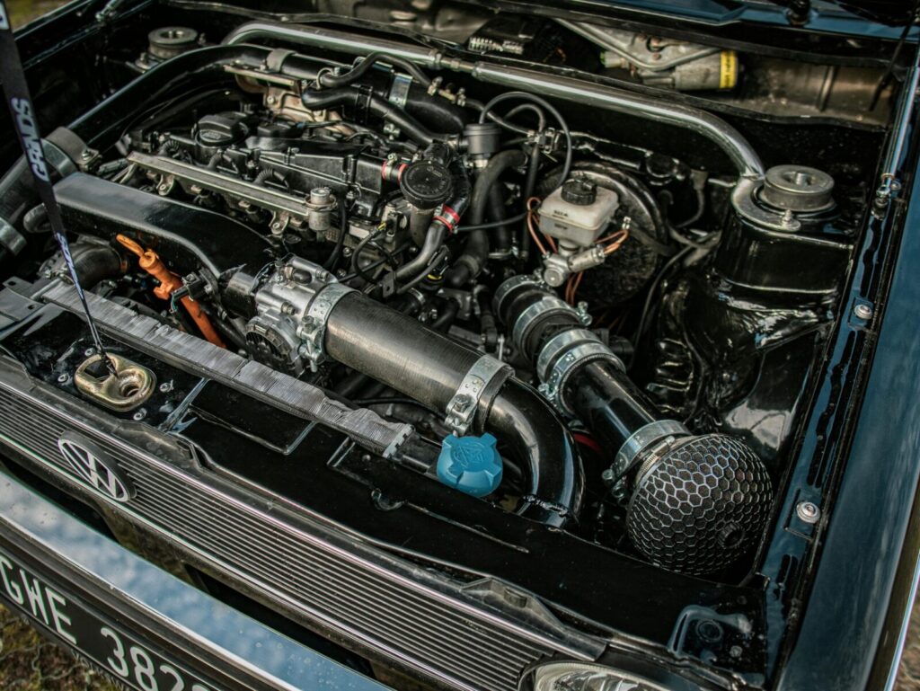 Close-up of a high-performance car engine under an open hood, showcasing mechanical details and engineering excellence.