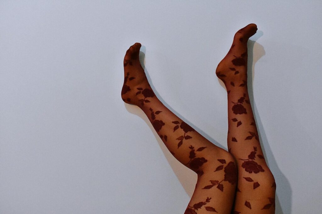Elegant floral-patterned stockings showcased with smooth, minimal background.