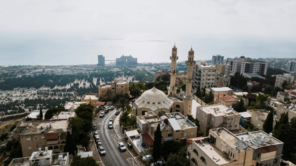 Aerial view of Haifa cityscape featuring residential area and mosque.